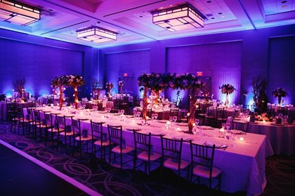 decorated banquet hall with flowers, rectangle table, chiavari c